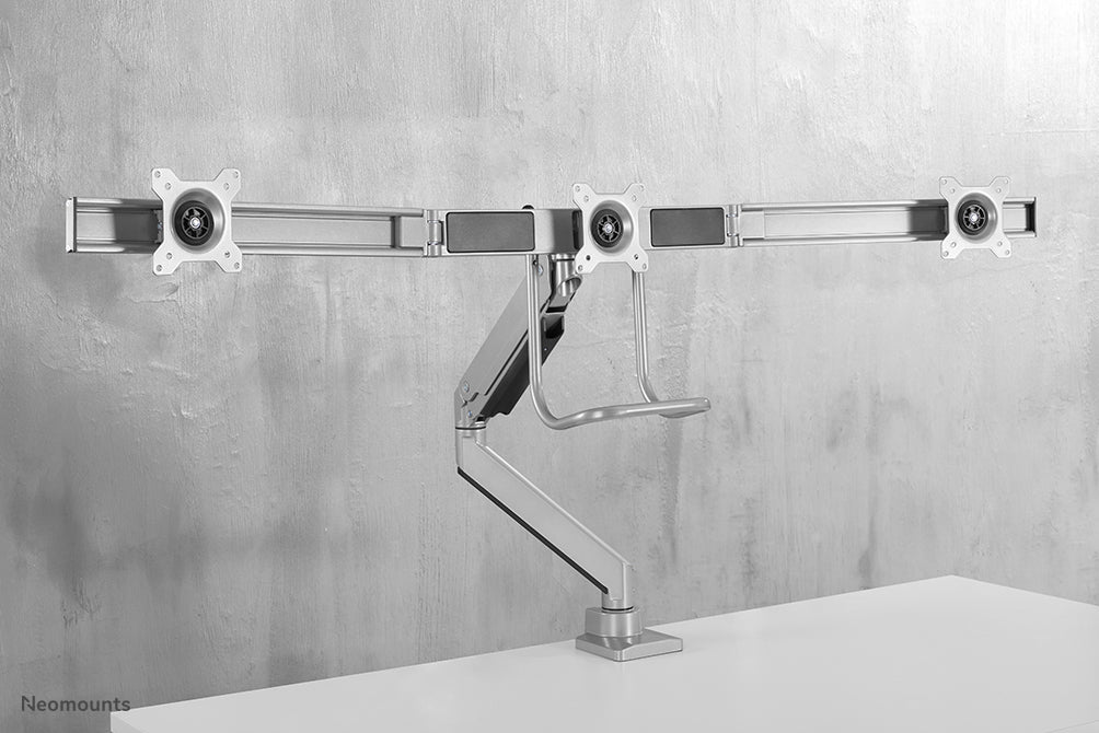Neomounts NM-D775DX3 silver är ett gasfjädrat skrivbordsstöd med tvärstång och handtag för platta skärmar upp till 27 tum (68,6 cm).